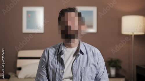 Hidden identity, hidden face, unknown person, silhouette interview. Man talks to camera or to interviewer, his face is hidden