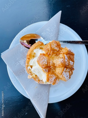 Original bayerischer Windbeutel mit Sahne-Creme-Füllung als Dessert auf dem Münchener Oktoberfest 