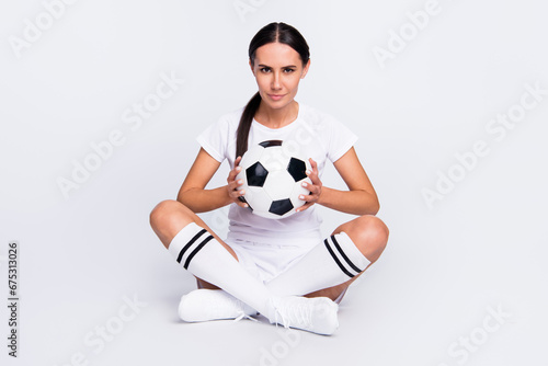Full size photo of cheerful happy young woman hold hands ball ready game isolated on grey color background