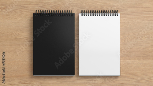 Notebook mockup. Closed and open blank notebook with black cover. Spiral notepad on wooden background