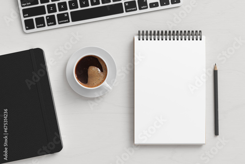 Notebook mockup. Blank workplace notebook. Spiral notepad on white wooden desk photo