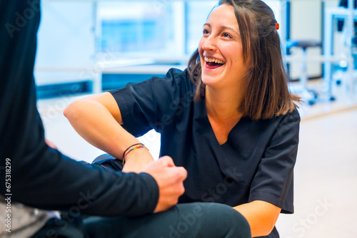 Free Download Mechanical exoskeleton. Physiotherapy smiling in modern hospital: Female physiotherapist helping disabled person with robotic skeleton with tapes. Futuristic rehabilitation - GFXLoad