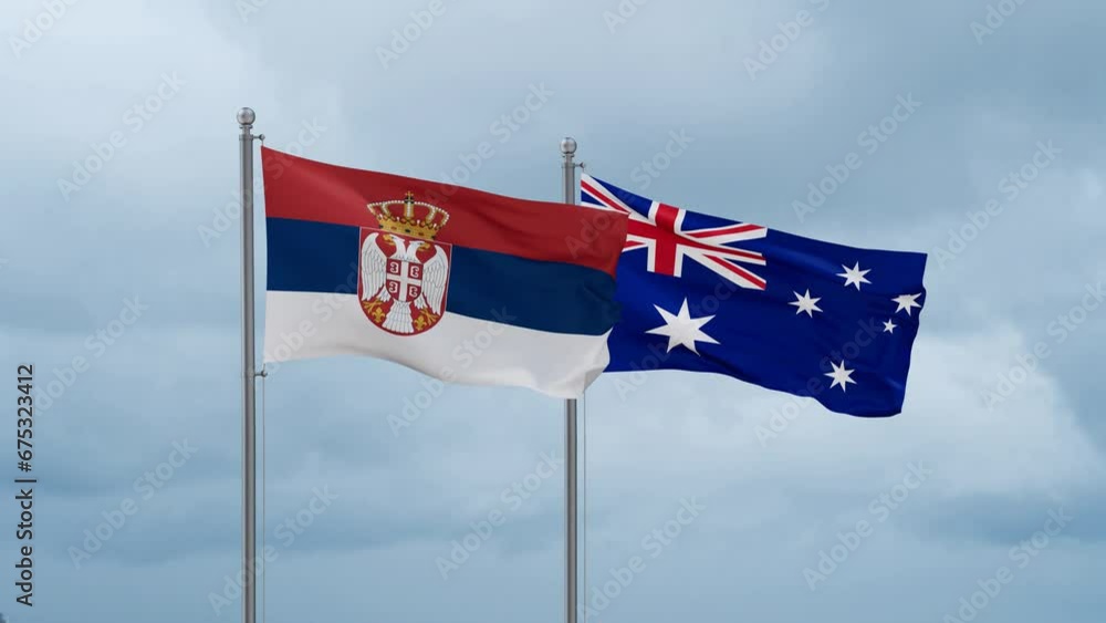 Australia flag and Serbia flag waving together on cloudy sky, endless seamless loop, two country relations concept Australia flag and Serbia flag waving together on cloudy sky, endless seamless loop, two country relations concept