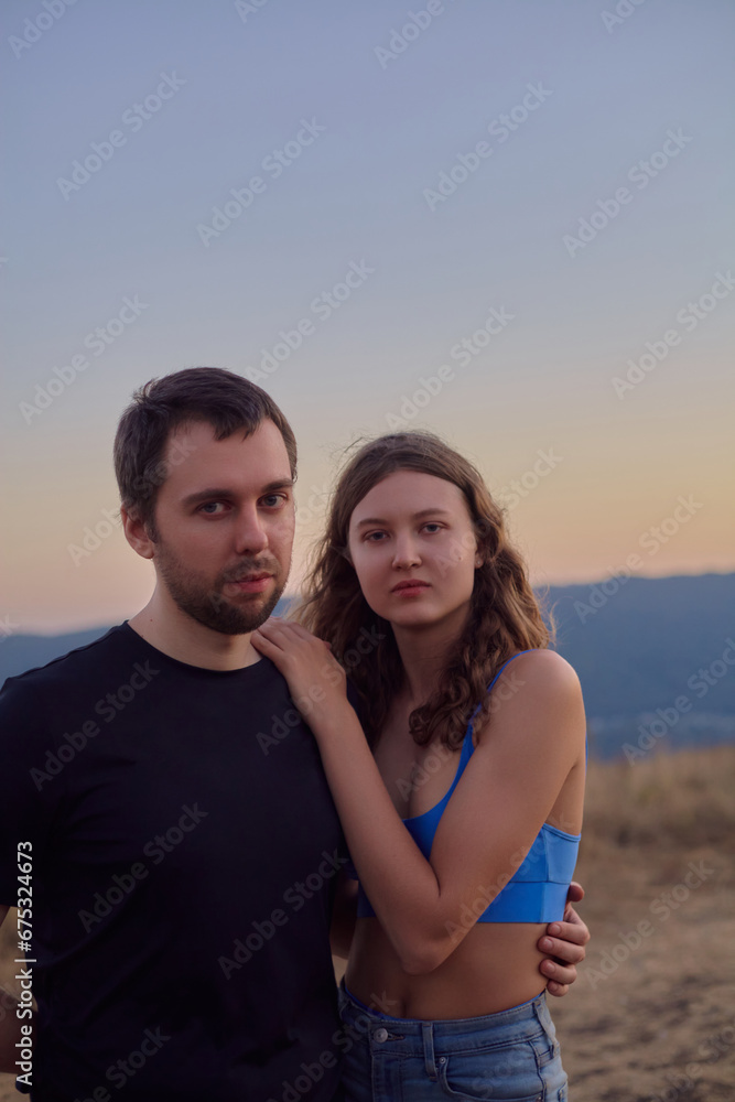 portrait of a happy couple in the mountains against the sunset portrait of a happy couple in the mountains against the sunset