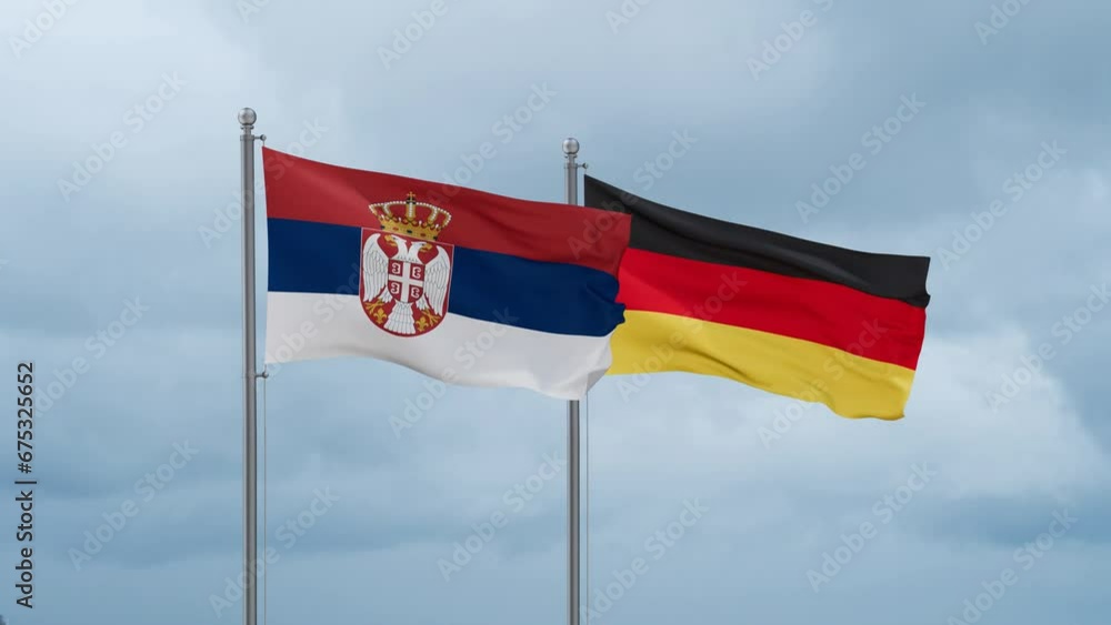Germany flag and Serbia flag waving together on cloudy sky, endless seamless loop, two country relations concept Germany flag and Serbia flag waving together on cloudy sky, endless seamless loop, two country relations concept