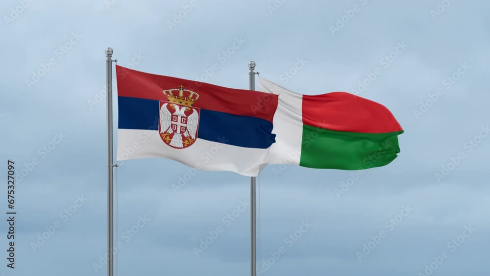 Madagascar flag and Serbia flag waving together on cloudy sky, endless seamless loop, two country relations concept Madagascar flag and Serbia flag waving together on cloudy sky, endless seamless loop, two country relations concept