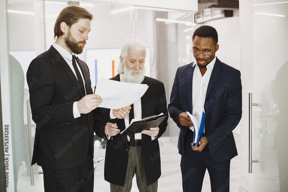 Three busines partners men in the office Three busines partners men in the office