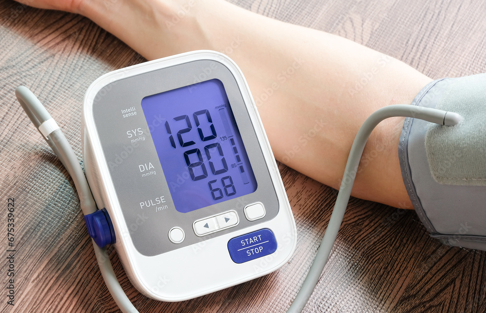 man check blood pressure monitor and heart rate monitor with digital pressure gauge. Health care and Medical concept man check blood pressure monitor and heart rate monitor with digital pressure gauge. Health care and Medical concept