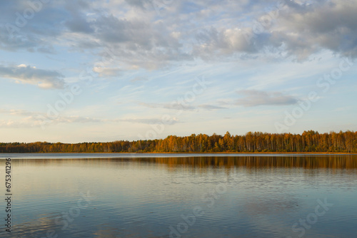 Autumn landscape. Lake at sunset in the autumn evening.