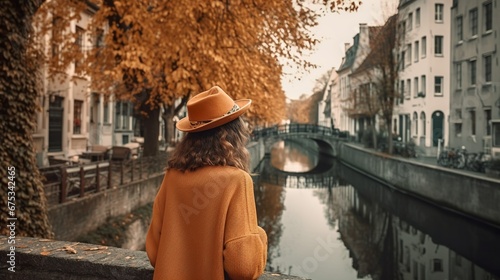 Woman in a hat sightseeing in a cozy small old town in  Autumn  © Hdi