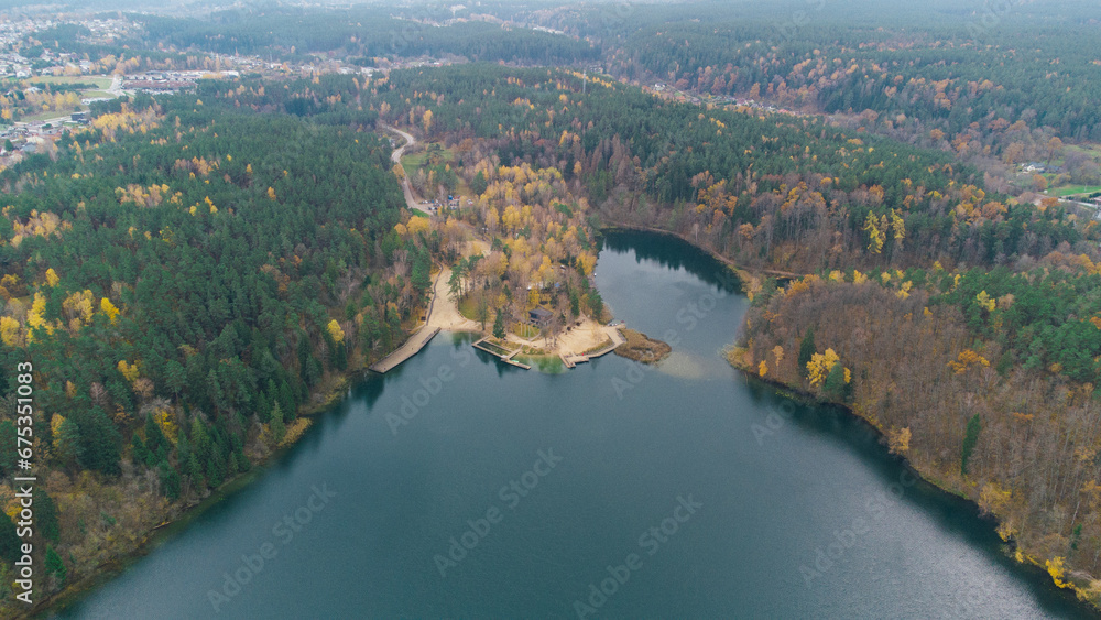 Autumn lake, river around fall color. Drone aerial nature view. Water and forest