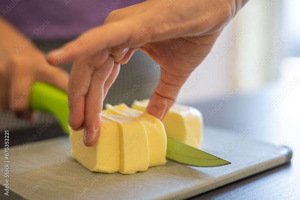 Little Chef's Delight: Close-Up of Kid's Hands Cutting Butter Little Chef's Delight: Close-Up of Kid's Hands Cutting Butter