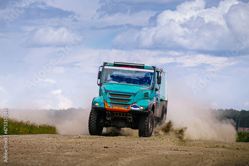 racing truck high speed moving on terrain road during cross country rally © sports photos