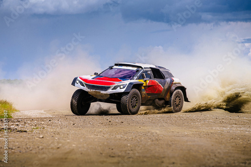 racing auto high speed moving on terrain road during cross country rally photo