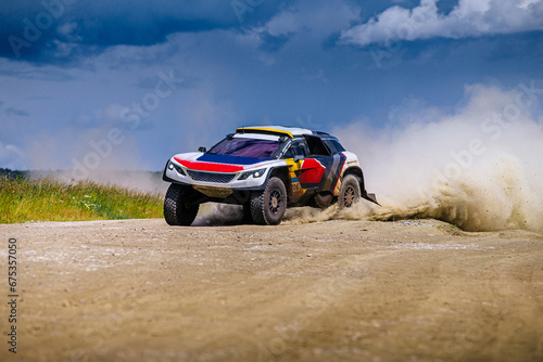 Fototapeta Naklejka Na Ścianę i Meble -  racing auto high speed rides on dusty road during cross country rally