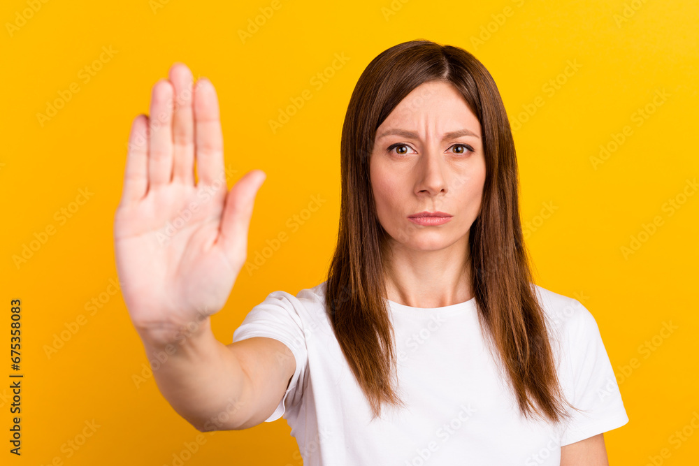 Closeup photo of young unhappy woman wear white t-shirt showing palms no restriction isolated on yellow color background Closeup photo of young unhappy woman wear white t-shirt showing palms no restriction isolated on yellow color background