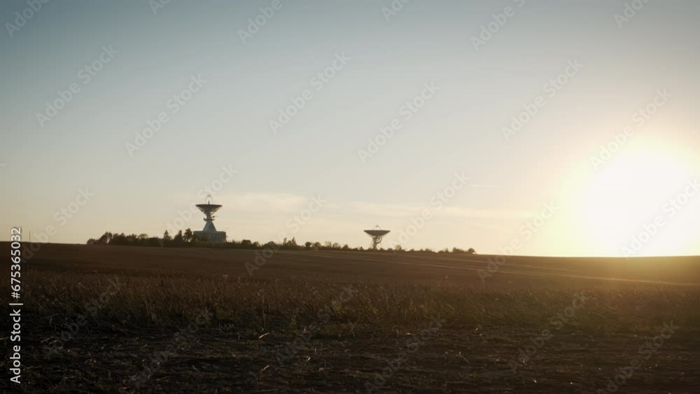Wide Aerial drone shot of two telecommunications antenna or Radio telescope satellite dish on sunset Wide Aerial drone shot of two telecommunications antenna or Radio telescope satellite dish on sunset