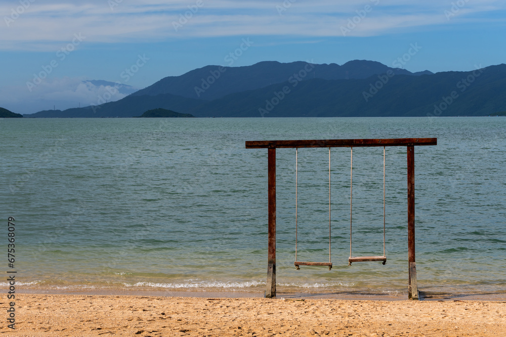 Wooden swing on the beach of a tropical island