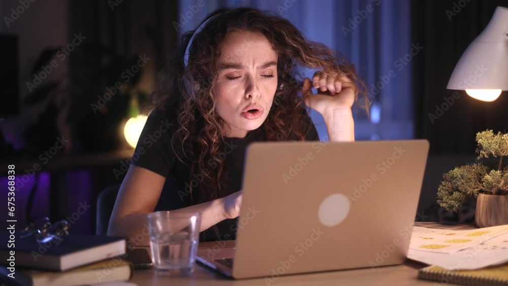 Portrait of boring young curly woman scrolling on laptop computer while find incredible news promotion sale and extremely happy at late night at home Advise Approve Recommend Choice concept Portrait of boring young curly woman scrolling on laptop computer while find incredible news promotion sale and extremely happy at late night at home Advise Approve Recommend Choice concept