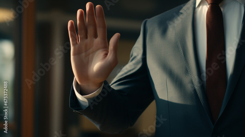 Young male politician raising his hand to swear photo