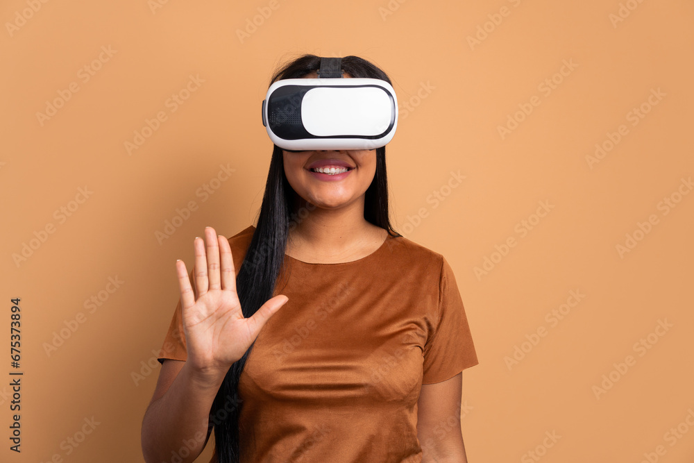 happy afro brazilian woman Using VR headset and gesturing in studio shot. virtual reality, technology simulation concept. happy afro brazilian woman Using VR headset and gesturing in studio shot. virtual reality, technology simulation concept.