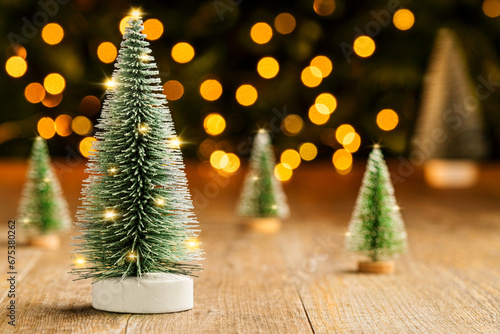 Christmas tree on old wooden table, lights background