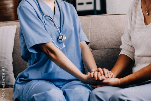 Happy senior woman visiting doctor, getting optimistic news after medical checkup, therapy. Therapist holding hand of old patient, giving hope, support, congratulating on goor treatment result © ARMMY PICCA