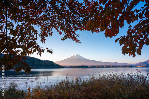 Colorful nature background of autumn forest tree season and Mountain Fuji with morning fog and red leaves at lake Kawaguchiko with blue sky, best landmark places to travel in Japan tourism © chokniti