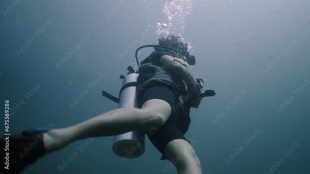Caucasian diving girl moving in the water in Thailand Caucasian diving girl moving in the water in Thailand