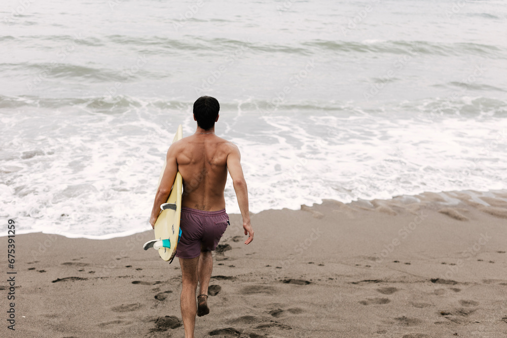 Handsome surfer with his surfboard. Young man enjoy at the beach. Handsome surfer with his surfboard. Young man enjoy at the beach.