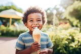 boy eating ice cream in a waffle cone at an outdoor