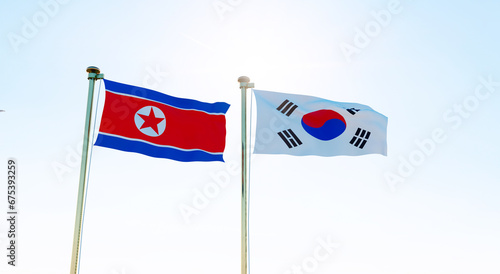 North Korea and South Korea flags waving together on blue sky. 4K ULTRA HD. 