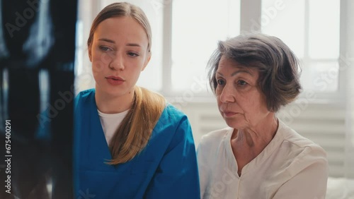 Wallpaper Mural Young doctor holding x-ray and explaining diagnosis to senior female patient Torontodigital.ca