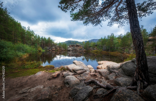 lake among rocks and forest on sunny autumn day. The famous Devil Lake in Karkaralinsk national park in Kazakhstan photo