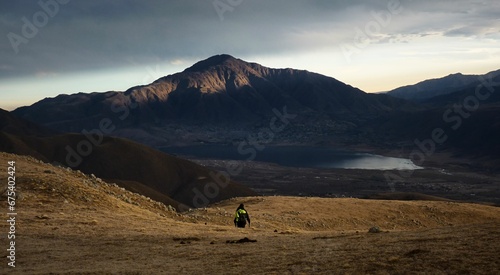 Man is enjoying the view of a majestic mountain in Tafi del Valle, Argentina photo