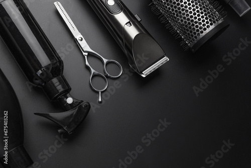 Barbershop concept. Hairdressing tools on dark background top view space for text. Hair extensions, materials and cosmetics, hair care, wig. Hairstyle, haircut in salon.