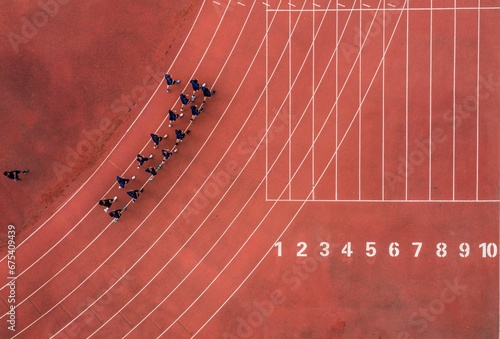 Aerial view of a running track with a group of runners.