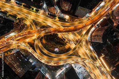 Aerial view of a bustling nighttime cityscape of a large intersection