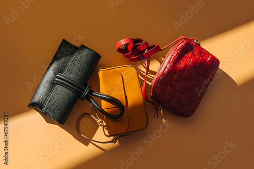 Various leather handbags. Fashion women's handbags on red background. Stylish accessories. Different Trendy Bags. photo