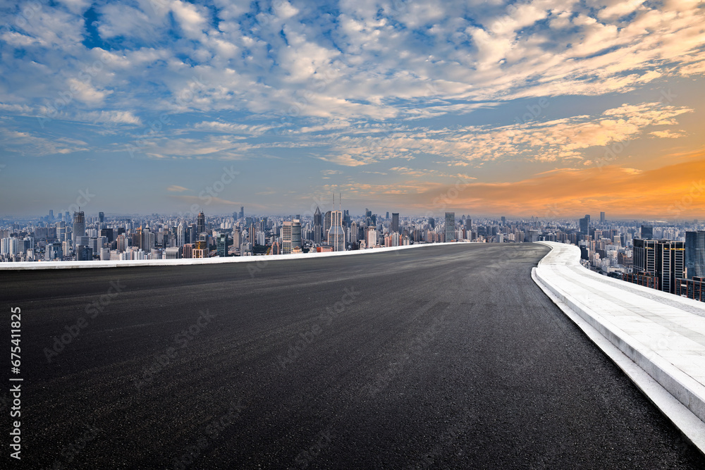 Fototapeta premium Asphalt road and city buildings skyline background in Shanghai