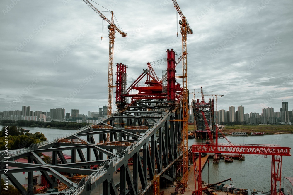 Hanjiangwan Bridge in its construction phase, with partially built pillars and steel cables.
