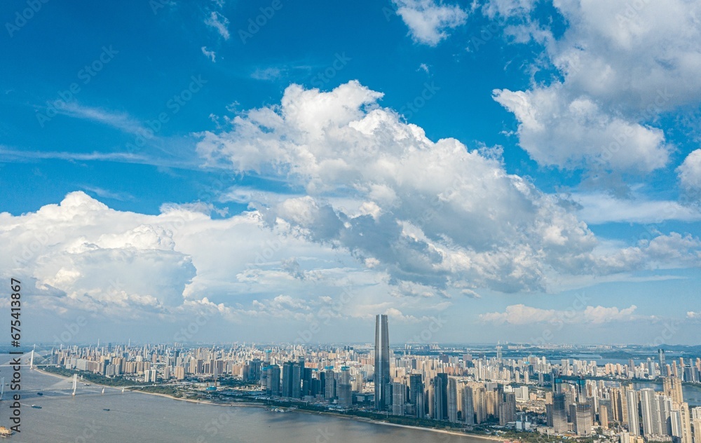 Aerial view of a vibrant metropolitan cityscape featuring a cluster of buildings: Wuhan