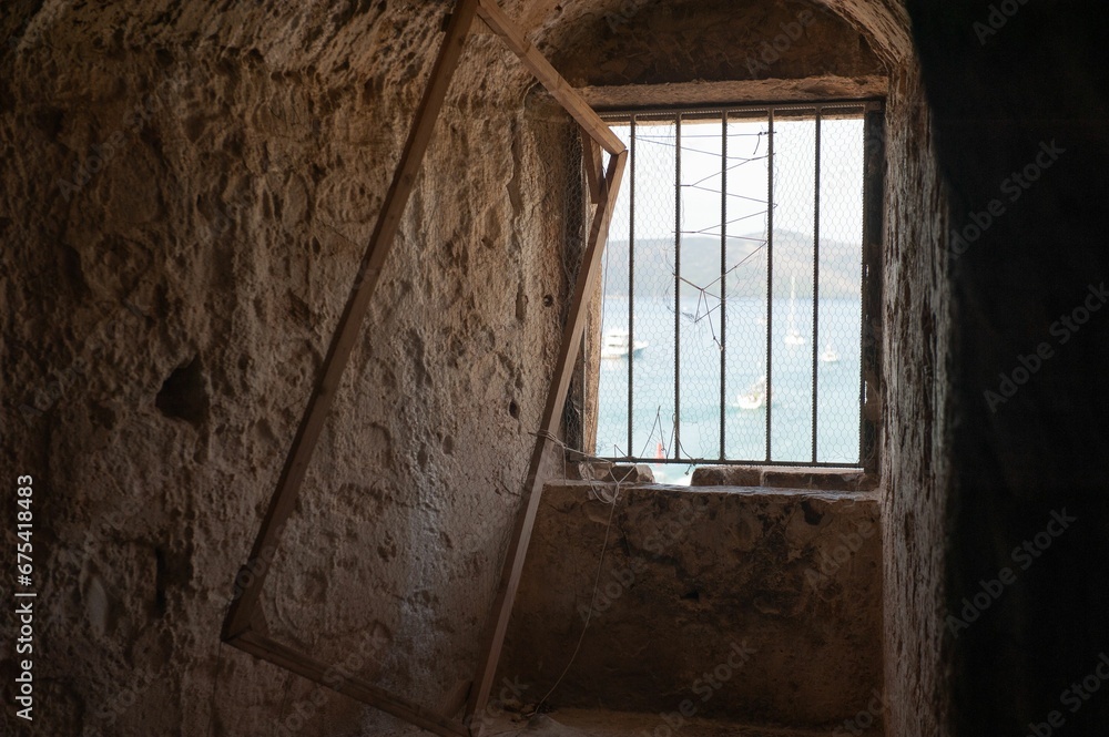 Old metal window frame inside Kamerlengo Castle in Croatia.