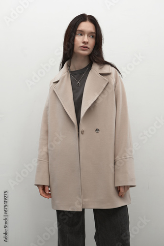 Beautiful fashion girl posing in a stylish coat