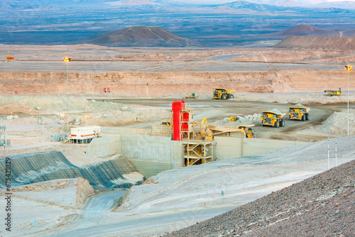 Huge large dump trucks at an open-pit copper mine in Chile.