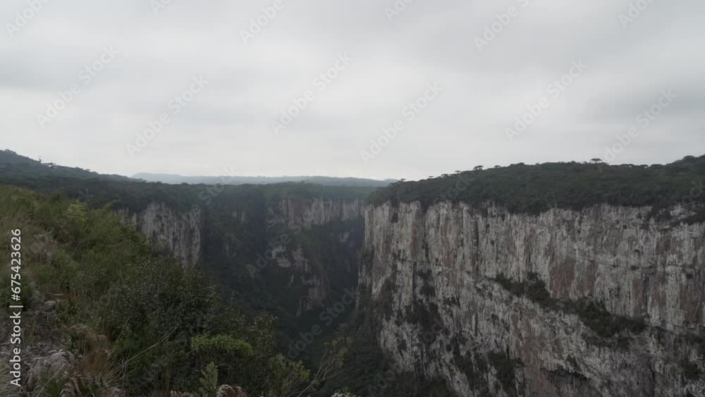 Itaimbezinho canyon at the Aparados da Serra National Park, located in the Serra Geral range of Rio Grande do Sul and Santa Catarina between coastal forests, grasslands and Araucaria moist forests. Itaimbezinho canyon at the Aparados da Serra National Park, located in the Serra Geral range of Rio Grande do Sul and Santa Catarina between coastal forests, grasslands and Araucaria moist forests.