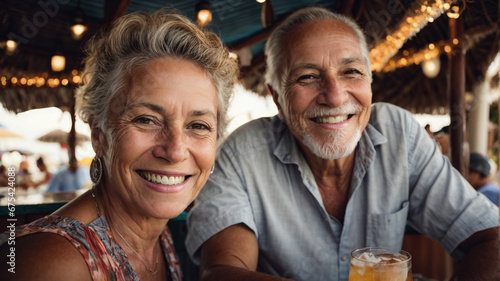 portrait of a mature caucasian spontaneous couple smiling in a restaurant outside on vacation, taking a selfie, concept of enjoyment in old age photo