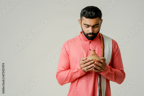 young indian farmer holding piggy bank or Gullak, Investment and banking concept. photo