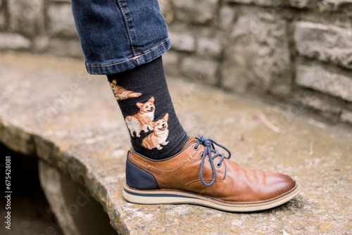 man wearing corgi socks and brown shoes
