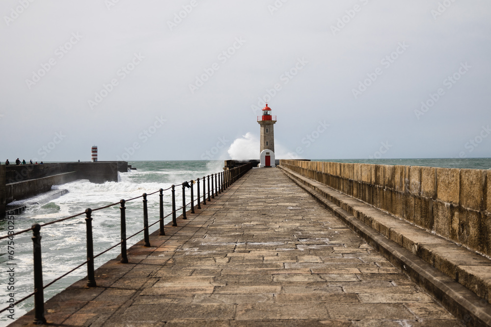Felgueiras Lighthouse in Porto on the Atlantic coast with huge waves in a sunny day, splashing waves at Farol de Felgueiras Felgueiras Lighthouse in Porto on the Atlantic coast with huge waves in a sunny day, splashing waves at Farol de Felgueiras